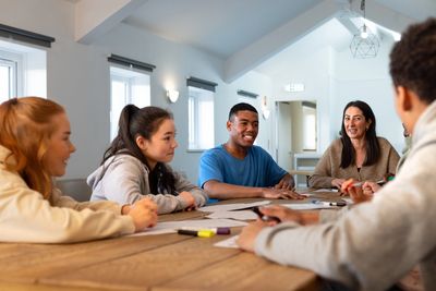 Image of people sitting around a table having a meeting.
