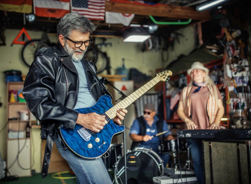 senior friends playing music in the garage reminiscing about the past
