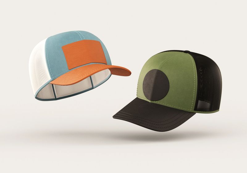 Two floating trucker caps mockup with blank logo space for branding design isolated on a neutral background in realistic 3D rendering. Baseball hat template and sport apparel concept