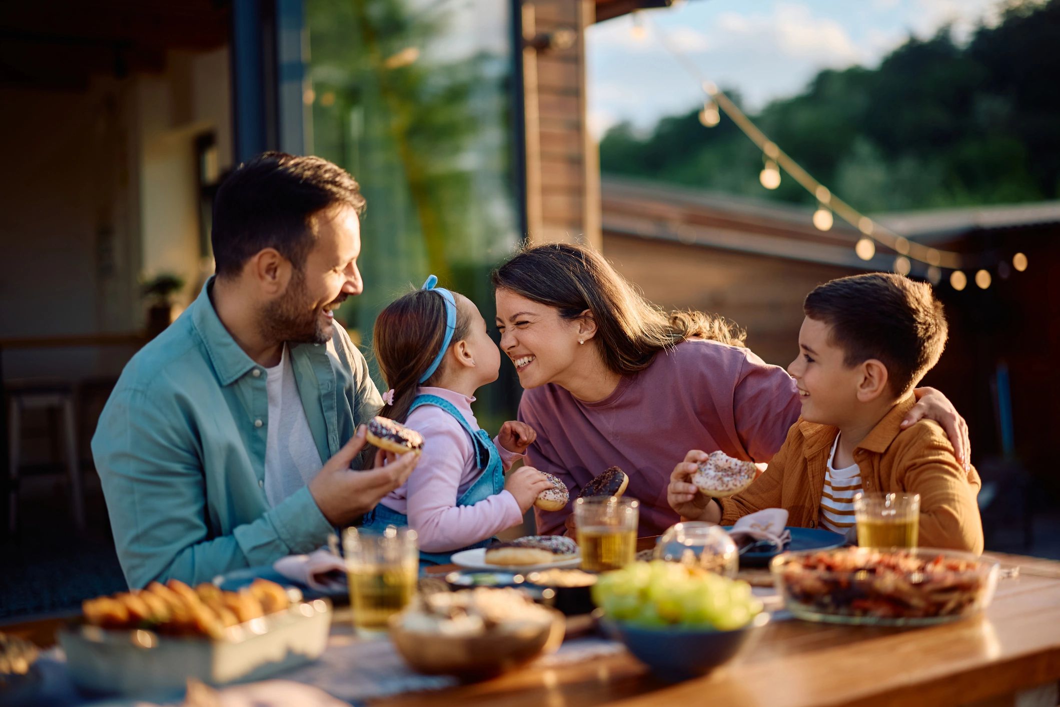A family smiling and eating at a table