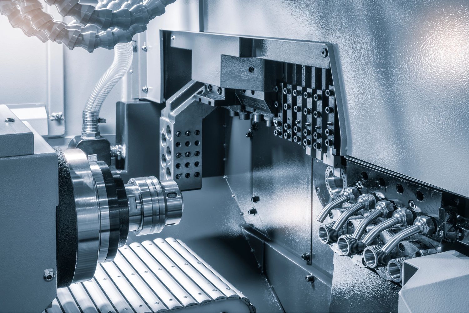 Close-up of a CNC machine's metalworking components in a factory.