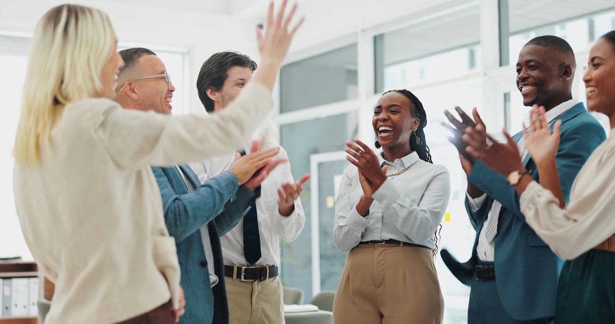Group of office workers clapping and smiling