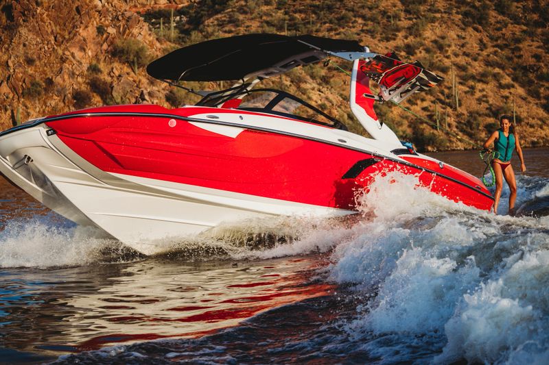 Motorboat pulls young girl on waterskis on resevoir