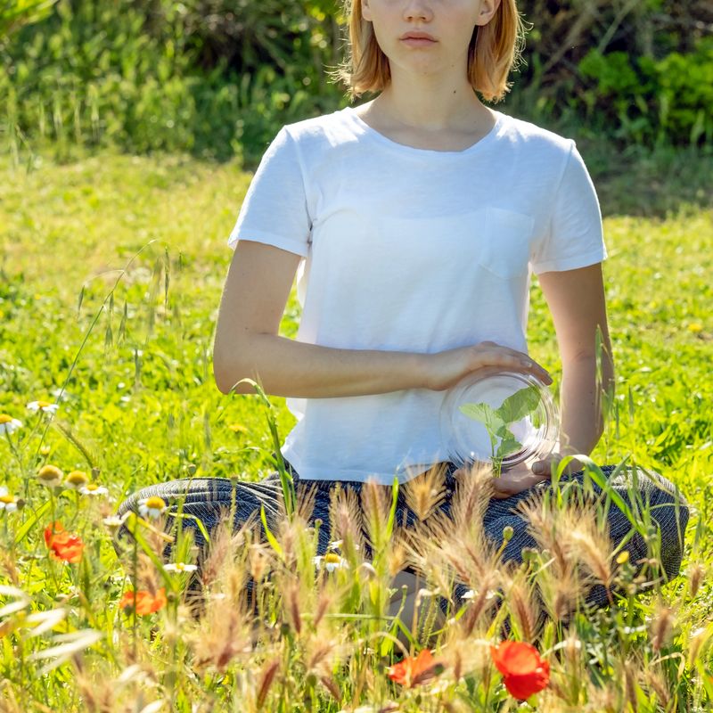 girl with green sprout in glass sphere