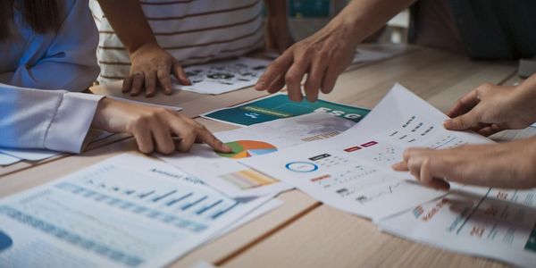 People analyzing charts and graphs during a business meeting.