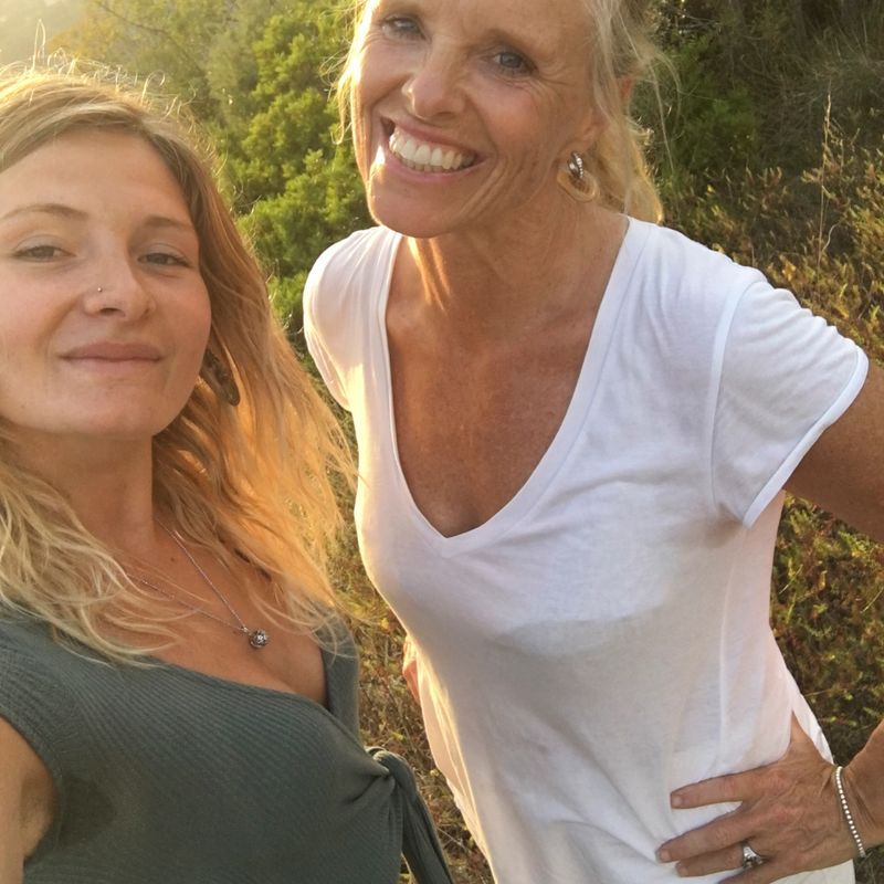 Selfie of mother and adult daughter in meadow while hiking