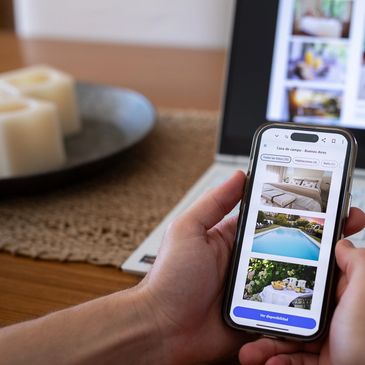 Person browsing vacation rental listings on a smartphone.