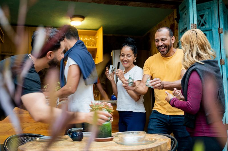 People sharing food and drinks in a restaurant