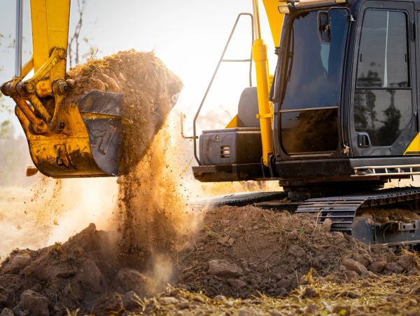 Excavator dumping soil during construction work.