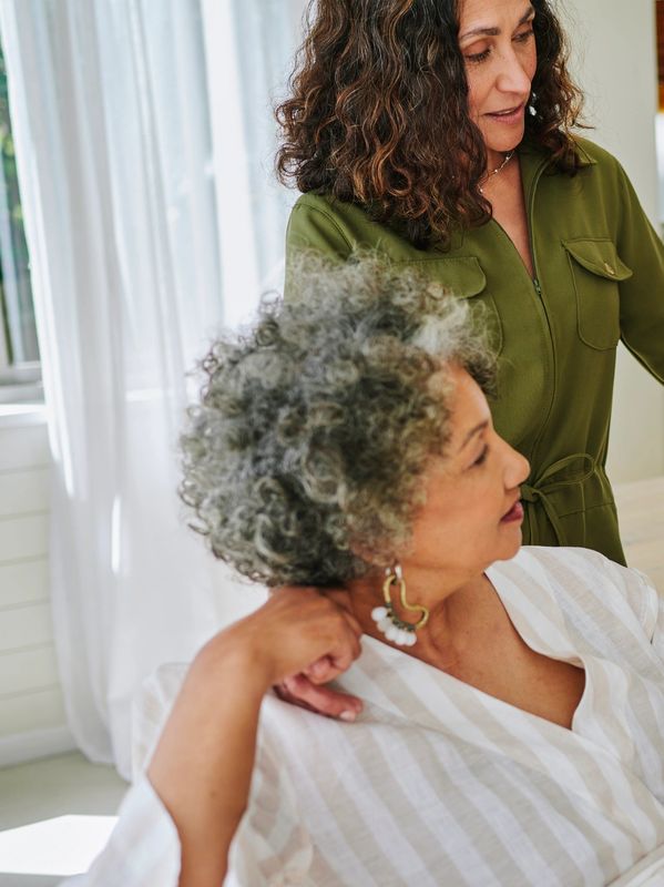 Three women sharing a happy moment indoors.