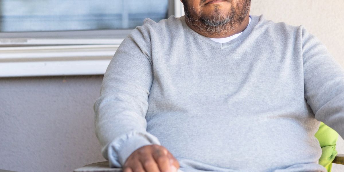 Homeowner reading a Notice of Default letter at their kitchen table