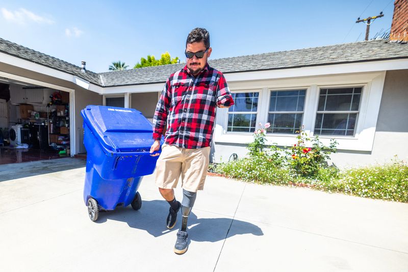 Disabled hispanic veteran taking out the recycling