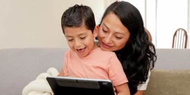 Mother and child enjoy a tablet together.