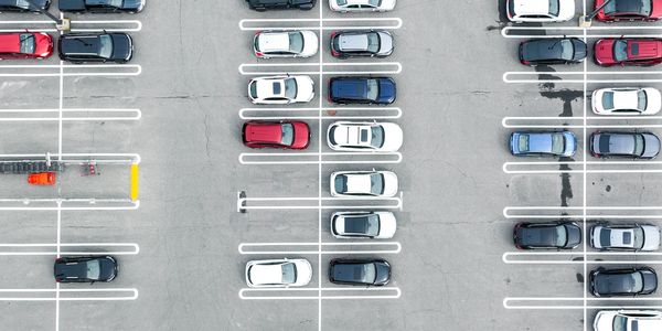 Aerial view of a parking lot with cars neatly parked in marked spaces.Parking ticket