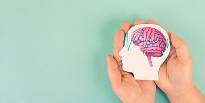 Hands holding a brain illustration with a heartbeat line inside a head silhouette.