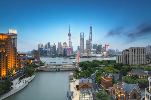 City skyline with river and bridges at dusk.