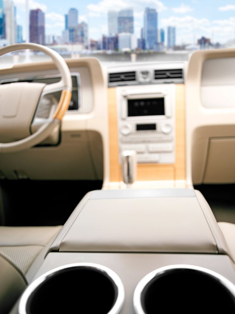 Luxury car parked in front of New York City skyscrapers