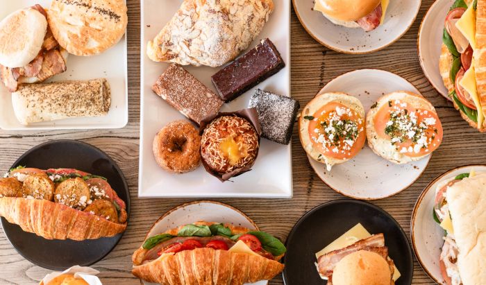 Variety of breakfast and lunch dishes including sandwiches, eggs, fries, and salads.