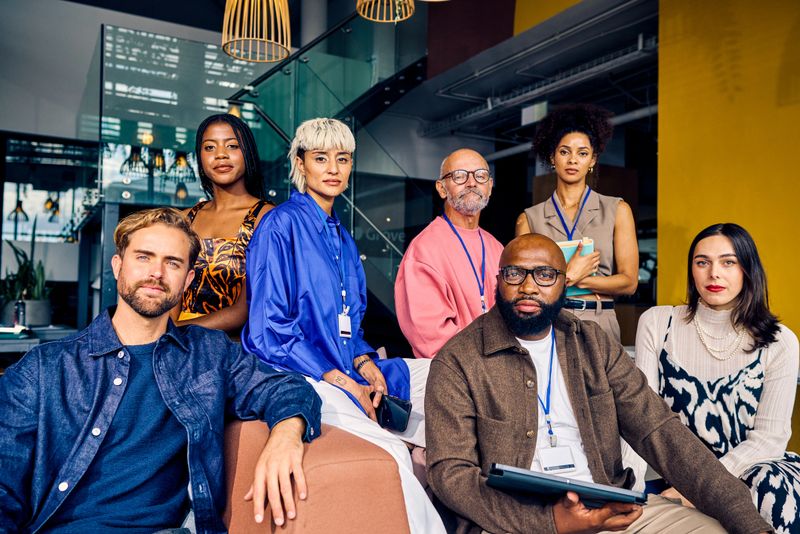 Multicultural corporate team in a modern office environment. Diversity and teamwork in business concept for design and print.