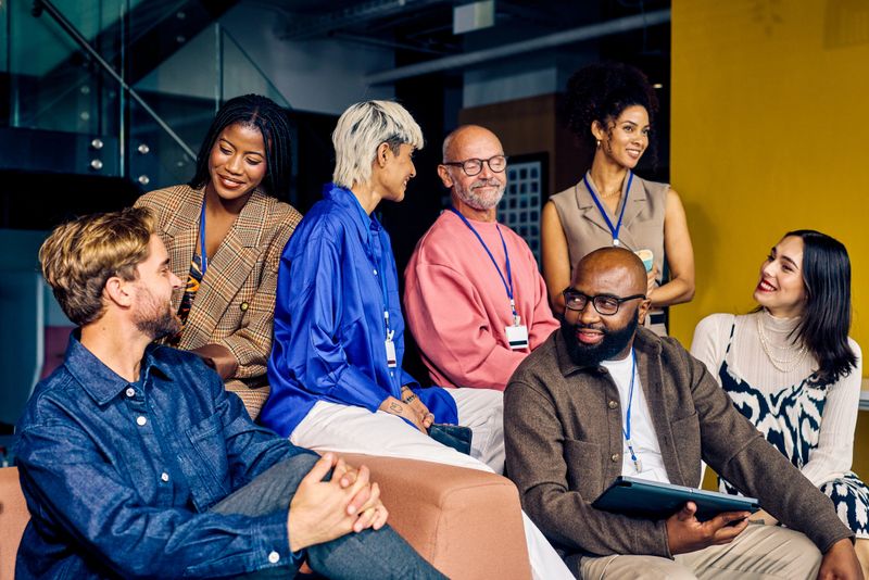 Multicultural corporate team in a modern office environment. Diversity and teamwork in business concept for design and print.