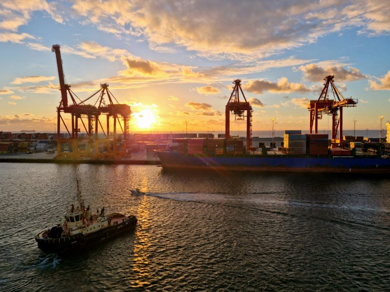 Container cranes on the Swan river with tug boat