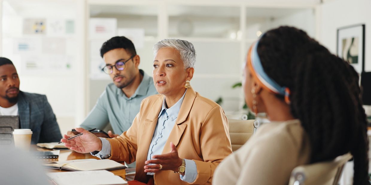 a group of people in a meeting 