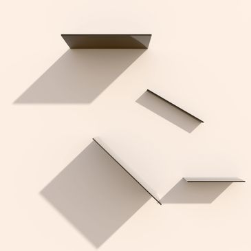 Minimalist shelves casting geometric shadows on a light wall.