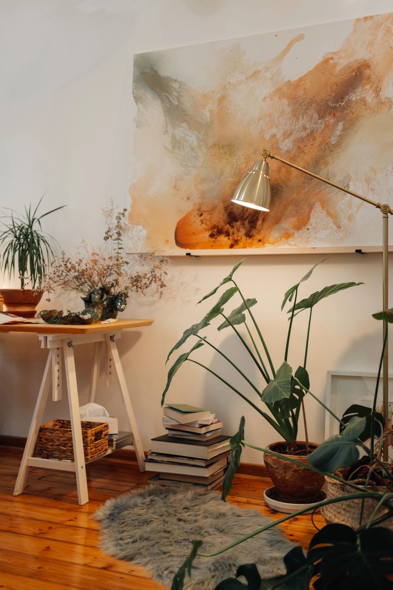 Creative art studio with painting on a wall and plants all around with no people. Artistic atelier with creative artwork hanging on the wall and houseplants all around with no people. Copy space.