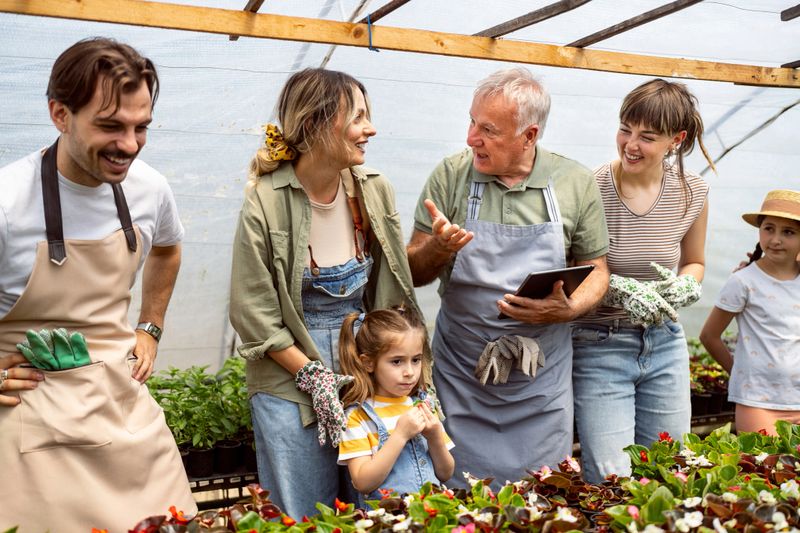 Small business owner, a Caucasian senior man, having an working day with family at the flower nursery