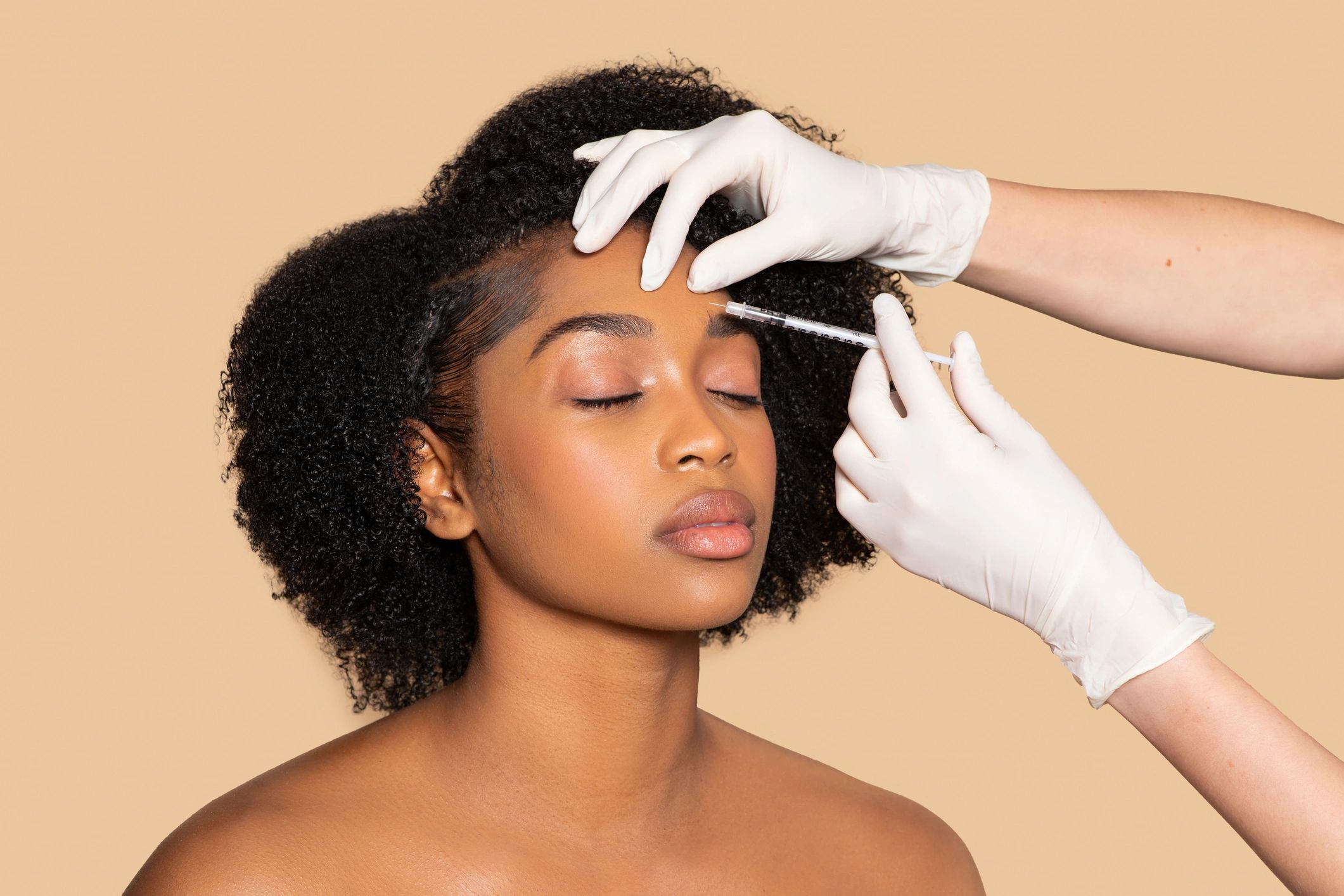 Woman receiving a forehead injection.