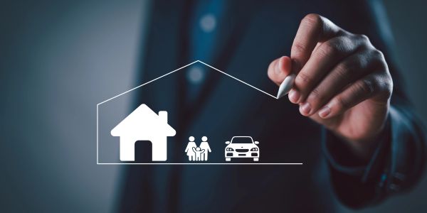 Hand drawing a house, family, and car icons.