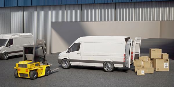 A forklift loads boxes into a white delivery van outside a warehouse.