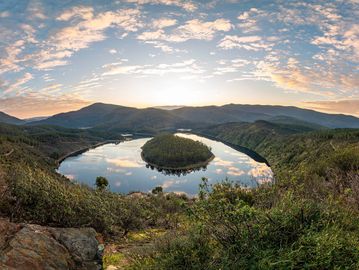 A wide angle view of a slow meandering river high above a bend