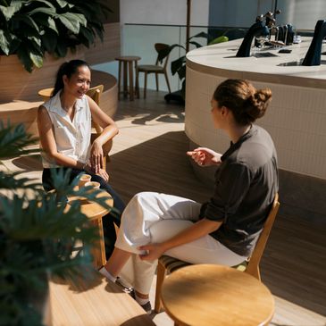 Two women chatting in a cozy cafe.