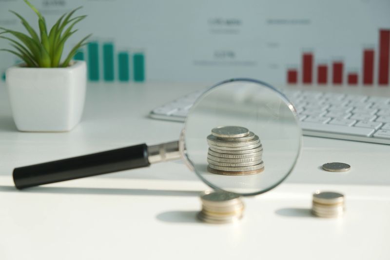 coins in a stack under a magnifying glass