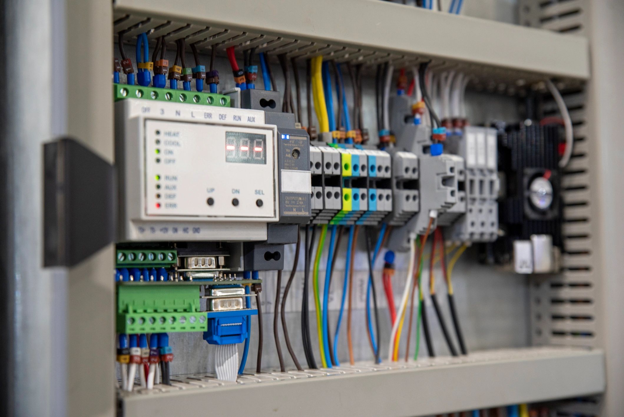 Close-up of an electrical control panel with colorful wiring and components.