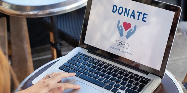 Person making an online donation on a laptop.