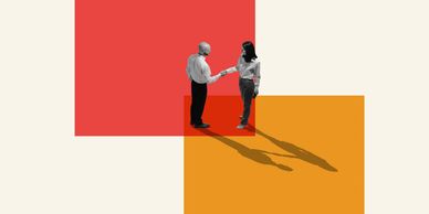 Two people shaking hands with extended shadows on colorful blocks.