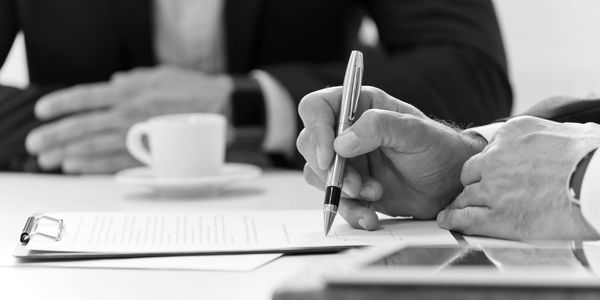 Business meeting with document signing.
