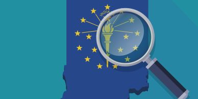 Magnifying glass highlighting torch on Indiana state map.