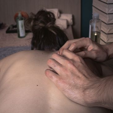 Person receiving a relaxing back massage with oil.