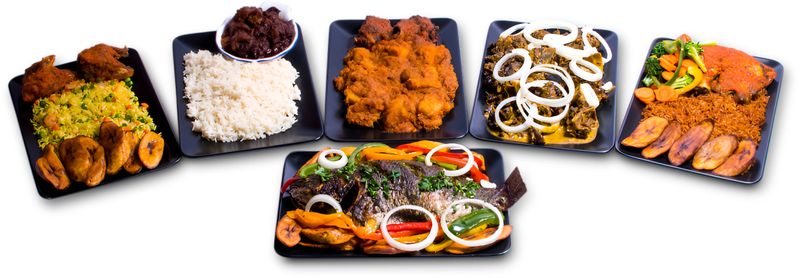 The image presents a delightful spread of culinary delights, featuring a plate of crispy fried chicken paired with vibrant yellow rice, a bowl brimming with savory stewed meat, and a plate of golden fried fish garnished with fresh lemon slices and herbs. Accompanying these are a dish of succulent grilled meat adorned with sliced onions and tomatoes, and a serving of flavorful jollof rice topped with onions, surrounded by ripe plantains. This enticing array of dishes is a testament to a rich food tradition, inviting one to explore the tastes and aromas of a diverse cuisine.