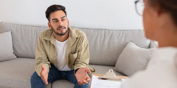 Man talking to a therapist during a counseling session.