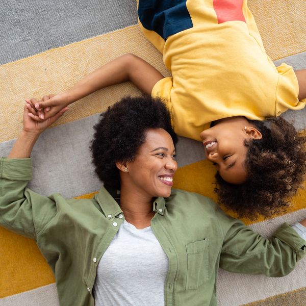 A woman and child taking Persian lessons looking at each othe