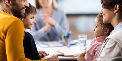 Happy family meeting with a professional in an office.