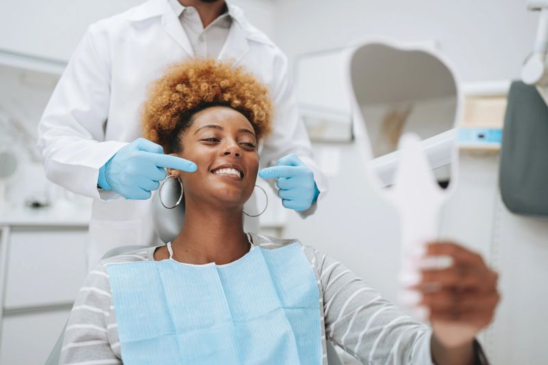 Woman at dentist holding mirror