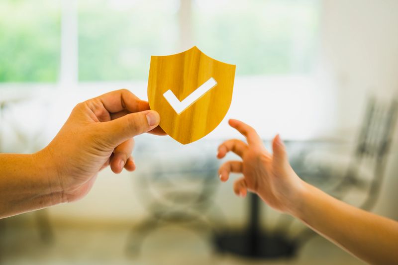 Businessman holding shield protect icon with his child, Security protection and health insurance. The concept of family home, protection, health care day, car insurance and home school education.