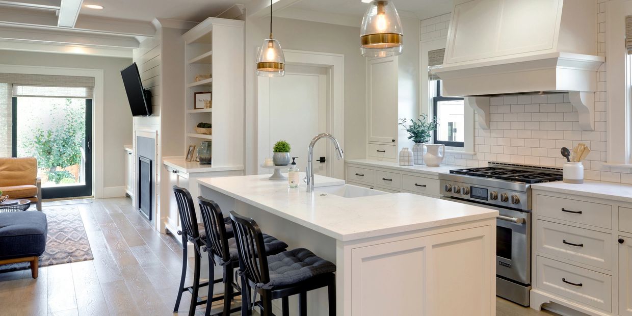 Modern clean kitchen with white countertops, subway tile on the backsplash and quartz countertops
