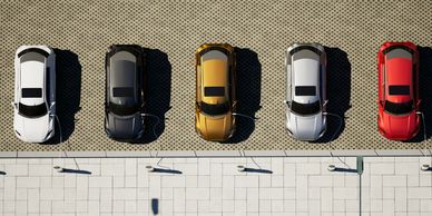 Five cars parked in a row with alternating colors.