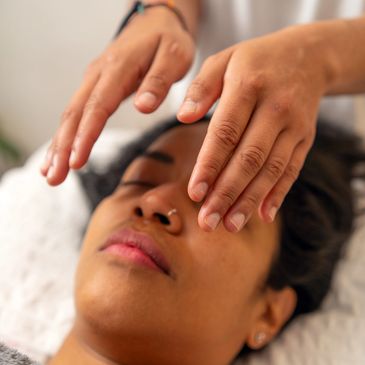 Reiki practitioner offering a calming hands-on energy session for deep relaxation.